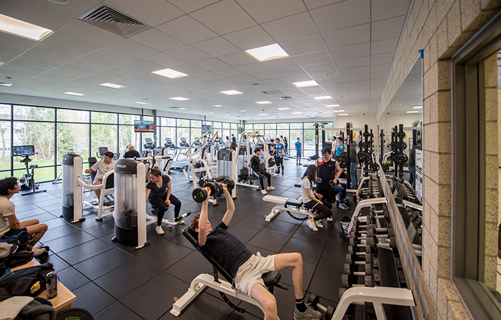 photo of  students using the Recreation and Athletics Center weight room 